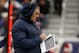 New England Patriots head coach Bill Belichick takes notes on the sideline in the first quarter of an NFL football game against the Cleveland Browns Sunday, Dec. 8, 2013, in Foxborough, Mass. (AP Photo/Elise Amendola)