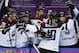 Latvia forward Lauris Darzins is congratulated by teammates after scoring against Switzerland in the third period of a men's ice hockey game at the 2014 Winter Olympics, Tuesday, Feb. 18, 2014, in Sochi, Russia. Latvia won 3-1 to advance to the quarterfinals. (AP Photo/Julio Cortez)