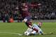 Barcelona's Lionel Messi is tackled down by Manchester City's Martin Demichelis and receives a penalty kick during their Champions League first knock out round soccer match at the Etihad Stadium, Manchester, England, Tuesday Feb. 18, 2014. (AP Photo/Jon Super)