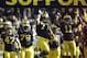 Michigan offensive linesman Taylor Lewan (77) and cornerback Courtney Avery (11) lead the team as they enter the stadium before the first quarter of an NCAA college football game against Ohio State in Ann Arbor, Mich., Saturday, Nov. 30, 2013. (AP Photo/Carlos Osorio)