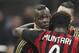 AC Milan forward Mario Balotelli, left, celebrates with his teammates Sulley Muntari, center, of Ghana, and Adil Rami, of France, after scoring during the Serie A soccer match between AC Milan and Bologna at the San Siro stadium in Milan, Italy, Friday, Feb. 14, 2014. (AP Photo/Antonio Calanni)
