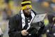 Pittsburgh Steelers quarterback Ben Roethlisberger (7) studies a book of photos on the sidelines during the second half of an NFL football game against the Cleveland Browns in Pittsburgh, Sunday, Dec. 29, 2013. The Steelers won 20-7. (AP Photo/Gene J. Puskar)