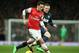 Arsenal's Mesut Ozil, left, shields the ball from Manchester United's Wayne Rooney during their English Premier League soccer match between Arsenal and Manchester United at the Emirates stadium in London, Wednesday, Feb. 12, 2014. (AP Photo/Alastair Grant)