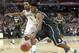 Michigan State guard Gary Harris drives on Kentucky guard James Young (1) during the second half of an NCAA college basketball game Tuesday, Nov. 12, 2013, in Chicago. Michigan State won 78-74. (AP Photo/Charles Rex Arbogast)