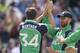 Ireland's Tim Murtagh, left, reacts with James Shannon, centre, and Trent Johnston, right, after Murtagh caught out Pakistan's Nasir Jamshaid during their One Day Cricket International at Clontarf Cricket Club, Dublin, Ireland, Sunday, May 26, 2013. (AP Photo/Peter Morrison)