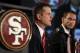 Jim Harbaugh, left, answers a question as San Francisco 49ers general manager Trent Baalke looks on during a news conference, Friday, Jan. 7, 2011, in San Francisco, introducing Harbaugh as the new head coach of the NFL football team. (AP Photo/Ben Margot)