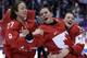 Canada's Tara Watchorn (27), Natalie Spooner (24) and Catherine Ward (18) celebrate after beating the USA 3-2 in overtime of the gold medal women's ice hockey game at the 2014 Winter Olympics, Wednesday, Feb. 19, 2014, in Sochi, Russia. (AP Photo/David Goldman)