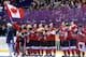 Team Canada sings the Canadian national anthem after receiving their gold medals after beating the USA 3-2 in overtime of the women's gold medal ice hockey game at the 2014 Winter Olympics, Friday, Feb. 21, 2014, in Sochi, Russia. (AP Photo/Mark Humphrey)