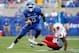 LEXINGTON, KY - SEPTEMBER 19: Chris Matthews #8 of the Kentucky Wildcats runs with the ball while defended by Anthony Conner #35 of the Louisville Cardinals during the game at Commonwealth Stadium on September 19, 2009 in Lexington, Kentucky. (Photo by Andy Lyons/Getty Images)