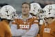 Texas' David Ash, center, watches teammates prepare for an NCAA college football game against Texas Tech, Thursday, Nov. 28, 2013, in Austin, Texas. Ash, who has missed most of the season with concussion symptoms, will not return to action until spring practice. (AP Photo/Eric Gay)