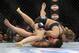 Ronda Rousey, of Venice, Calif., and Miesha Tate, of Yakima, Wash., battle it out during the UFC 168 mixed martial arts women's bantamweight title fight on Saturday, Dec. 28, 2013, in Las Vegas. Rousey won by a third round tap out. (AP Photo/David Becker)