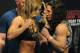 Feb 21, 2014; Las Vegas, NV, USA; Ronda Rousey (L) and Sara McMann (R) face off for photographs during the UFC 170 weigh-in at Mandalay Bay Events Center. Mandatory Credit: Stephen R. Sylvanie-USA TODAY Sports