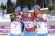 Russia's gold medal winner Alexander Legkov is flanked by Russia's silver medal winner Maxim Vylegzhanin, left and Russia's bronze medal winner Ilia Chernousov during the flower ceremony of the men's 50K cross-country race at the 2014 Winter Olympics, Sunday, Feb. 23, 2014, in Krasnaya Polyana, Russia. (AP Photo/Gregorio Borgia)