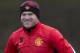 Manchester United's Wayne Rooney smiles as he trains with teammates at Carrington training ground in Manchester, Monday, Feb. 24, 2014. Manchester United will play Olympiakos in a Champions League first knockout round on Tuesday. (AP Photo/Jon Super)