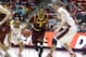 Arizona State's Jahii Carson (1) drives between Utah's Brandon Taylor (11) and Dallin Bachynski (31) in the first half of an NCAA college basketball game Sunday, Feb. 23, 2014, in Salt Lake City. (AP Photo/Rick Bowmer)
