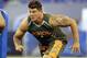 Michigan offensive lineman Taylor Lewan runs a drill at the NFL football scouting combine in Indianapolis, Saturday, Feb. 22, 2014. (AP Photo/Michael Conroy)