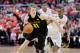 Wichita State guard Ron Baker (31) pushes down the court past the defense of Bradley guard Ka'Darryl Bell (0) during the first half of an NCAA college basketball game at Carver Arena, Tuesday, Feb. 25, 2014, in Peoria, Ill. (AP Photo/ Stephen Haas)