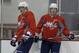 Washington Capitals captain Alex Ovechkin, left, and center Nicklas Backstrom pause during a Capitals hockey practice, Tuesday, Feb. 25, 2014, at Kettler Capitals Iceplex in Arlington, Va. Ovechkin's father had heart surgery, and Backstrom missed the gold medal game because of a failed doping test. Both players are back from an eventful Olympics. (AP Photo/Carolyn Kaster)