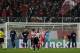 Olympiakos' and Manchester United's players react after Italian's referee Gianluca Rocchi, left, blew the final whistle during a Champions League, round of 16, first leg soccer match against Olympiakos at Georgios Karaiskakis stadium, in Piraeus port, near Athens, on Tuesday, Feb. 25, 2014. Olympiakos won 2-0. (AP Photo/Thanassis Stavrakis)