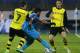Borussia's Jonas Hofmann, left, and Erik Durm, right, stop Zenit's Hulk during the Champions League soccer match between Zenit St.Petersburg and Borussia Dortmund at Petrovsky stadium in St.Petersburg, Russia, on Tuesday, Feb. 25, 2014. (AP Photo/Dmitry Lovetsky)