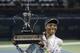 Venus Williams of the U.S. holds the trophy after she beat Alize Cornet of France during the final match of Dubai Duty Free Tennis Championships in Dubai, United Arab Emirates, Saturday, Feb. 22, 2014. (AP Photo/Kamran Jebreili)