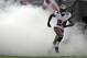 Tampa Bay Buccaneers cornerback Darrelle Revis (24) runs through smoke during team introductions before an NFL football game against the New Orleans Saints Sunday, Sept. 15, 2013, in Tampa, Fla. (AP Photo/Chris O'Meara)