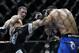 Rory MacDonald, left, kicks Demian Maia during a UFC 170 mixed martial arts welterweight fight on Saturday, Feb. 22, 2014, in Las Vegas. MacDonald won by unanimous decision. (AP Photo/Isaac Brekken)