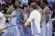 North Carolina's Leslie McDonald hugs Marcus Paige (5) as teammates celebrate Paige's shot in overtime following an NCAA college basketball game in Raleigh, N.C., Wednesday, Feb. 26, 2014. North Carolina defeated North Carolina State 85-84 in overtime. (AP Photo/Gerry Broome)