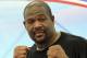 In this photo taken May 24, 2014, former world heavyweight boxing champion Riddick Bowe poses while holding a boxing clinic to Thai vocational students in Lopburi province, central Thailand. For years, Riddick Bowe dreamed of getting back into the ring - just not this ring and this sport, in this country. Next week in Thailand, the former world heavyweight boxing champion the world will step out of retirement to make his debut as a Muay Thai fighter - the brutal martial art that makes boxing look gentlemanly. (AP Photo/Apichart Weerawong)