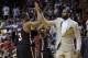 Miami Heat's LeBron James, right, high-fives Dwyane Wade (3) during a time out in the second half of an NBA basketball game against the Chicago Bulls, Sunday, Feb. 23, 2014, in Miami. The Heat defeated the Bulls 93-79. (AP Photo/Lynne Sladky)