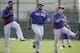 Texas Rangers' Adrian Beltre, left, Prince Fielder and Shin-Soo Choo of South Korea, right, participate in warm ups before a morning workout during spring training baseball practice, Wednesday, Feb. 19, 2014, in Surprise, Ariz. (AP Photo/Tony Gutierrez)