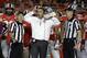 Ohio State coach Urban Meyer stands with officials as they wait for a ruling on the field during the first half of the Orange Bowl NCAA college football game against Clemson, Friday, Jan. 3, 2014, in Miami Gardens, Fla. (AP Photo/Lynne Sladky)