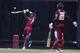 West Indies' Dwayne Bravo plays a shot for four runs of England's Chris Jordan as Darren Sammy looks on during their first one-day international cricket match at the Sir Vivian Richards Cricket Ground in St. John's, Antigua, Friday, Feb. 28, 2014. (AP Photo/Ricardo Mazalan)