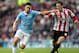 Manchester City's Samir Nasri, left, vies for the ball with Sunderland's Craig Gardner, right, during their English Premier League soccer match at the Stadium of Light, Sunderland, England, Sunday, Nov. 11, 2013. (AP Photo/Scott Heppell)
