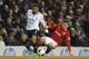 Tottenham Hotspur's Aaron Lennon, left, is tackled by Cardiff City's Declan John during their English Premier League soccer match at White Hart Lane, London, Sunday, March 2, 2014. (AP Photo/Sang Tan)