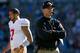 CHARLOTTE, NC - JANUARY 12: Head coach Jim Harbaugh of the San Francisco 49ers looks on in the second quarter as Colin Kaepernick #7 walks by against the Carolina Panthers during the NFC Divisional Playoff Game at Bank of America Stadium on January 12, 2014 in Charlotte, North Carolina. (Photo by Ronald Martinez/Getty Images)