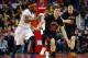 Newly signed Chicago Bulls guard Jimmer Fredette dribbles past New York Knicks guard Toure' Murry during the second half of an NBA basketball game on Sunday, March 2, 2014, in Chicago. The Bulls won 109-90. (AP Photo/Jeff Haynes)