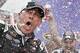 Kevin Harvick celebrates in Victory Lane with his crew after winning the NASCAR Sprint Cup Series auto race Sunday, March 2, 2014, in Avondale, Ariz. (AP Photo/Ross D. Franklin)