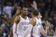 Oklahoma City Thunder forward Kevin Durant (35) and guard Russell Westbrook (0) exchange high fives in the first quarter of an NBA basketball game against the Minnesota Timberwolves in Oklahoma City, Sunday, Dec. 1, 2013. Timberwolves center Nikola Pekovic (14) is at right. Oklahoma City won 113-103. (AP Photo/Sue Ogrocki)