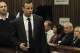 Oscar Pistorius is watched by June Steenkamp, right, the mother of Reeva Steenkamp, as he arrives for his trial at the high court in Pretoria, South Africa, Monday, March 3, 2014. Pistorius is charged with murder with premeditation in the shooting death of girlfriend Reeva Steenkamp in the pre-dawn hours of Valentine's Day 2013. (AP Photo/Themba Hadebe, Pool)