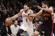 Brooklyn Nets guard Deron Williams (8) drives around Toronto Raptors guard Greivis Vasquez (21) in the first half of their NBA basketball game at the Barclays Center, Monday, Jan. 27, 2014, in New York. (AP Photo/Kathy Willens)
