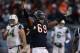 CHICAGO, IL - DECEMBER 26: Henry Melton #69 of the Chicago Bears celebrates after teammate Chris Harris intercepted a pass in the final minutes as Nick Mangold #74 and Mark Sanchez #6 of the New York Jets walk off of the field at Soldier Field on December 26, 2010 in Chicago, Illinois. The Bears defeated the Jets 38-34. (Photo by Jonathan Daniel/Getty Images)