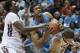 North Carolina's James McAdoo, center, grabs a rebound against Virginia Tech's C.J. Barksdale, left, and Will Johnston during the second half of an NCAA college basketball game, Saturday, March 1, 2014, in Blacksburg, Va. North Carolina won 60-56. (AP Photo/Don Petersen)