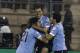 Uruguay's Maximiliano Pereira, right, celebrates with his teammates Edinson Cavani, left, and Luis Suarez after scoring the opening goal against Jordan during the World Cup play off first leg soccer match between Jordan and Uruguay at Amman International stadium in Amman, Jordan, Wednesday, Nov. 13, 2013. (AP Photo/Hassan Ammar)