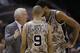 San Antonio Spurs coach Gregg Popovich, left, talks with Tony Parker (9), of France, and Tim Duncan, right, during the first half of an NBA basketball game, Wednesday, Nov. 13, 2013, in San Antonio. (AP Photo/Eric Gay)
