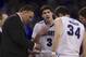 Creighton coach Greg McDermott looks at his notes with Doug McDermott (3) and Ethan Wragge (34) in the second half of an NCAA college basketball game against Seton Hall in Omaha, Neb., Sunday, Feb. 23, 2014. Creighton won 72-71. (AP Photo/Nati Harnik)