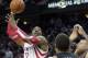 Houston Rockets center Dwight Howard takes a shot over Miami Heat forward Michael Beasley (8) during the fourth quarter of an NBA basketball game, Tuesday, March, 4, 2014, in Houston. The Rockets defeated the Heat 106-103. (AP Photo/Patric Schneider)