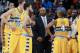 Denver Nuggets coach Brian Shaw, center, confers with players during a timeout against the Toronto Raptors in the fourth quarter of the Raptors' 100-90 victory in an NBA basketball game in Denver on Friday, Jan. 31, 2014. (AP Photo/David Zalubowski)