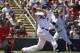 Minnesota Twins' Joe Mauer hits an RBI single off Boston Red Sox pitcher Allen Webster as Red Sox catcher A.J. Pierzynski, left, looks on in the first inning of an exhibition baseball game, Saturday, March 1, 2014, in Fort Myers, Fla. (AP Photo/Steven Senne)