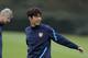Arsenal's Park Chu-Young takes part in a training session as French manager Arsene Wenger walks behind at the club's facilities in London Colney, England, Monday, Oct. 31, 2011. Arsenal are due to play Marseille in their Group F Champions League soccer match at the Emirates Stadium in London on Tuesday. (AP Photo/Matt Dunham)